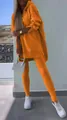 Detail view of vibrant orange two-piece lounge set with oversized hoodie and leggings - Orange