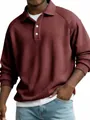 Close-up of men's burgundy waffle knit polo shirt with raglan sleeves and button collar - Red
