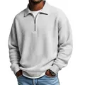 Detail of men's gray waffle knit polo shirt with half-zip collar and ribbed cuffs. - White
