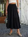 Black tiered maxi skirt with elastic waist shown in fashionable outdoor street style - S / Bottoms / Black