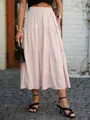 Detailed view of a pale pink tiered maxi skirt with elastic waist and textured fabric. - S / Bottoms / Pink