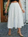 Detailed view of a white polka dot tiered maxi skirt styled for summer outdoor wear. - White Polka Dot