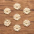 Detailed view of seven golden sunflower charms for DIY jewelry on rustic wood background. - KC Gold