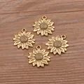 Close-up of four golden sunflower charms for DIY jewelry on a wood surface. - Antique Gold