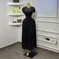 Dettaglio dell'abito lungo nero con corpetto in pizzo e paillettes scintillanti - Taglia S / Vestiti / Nero