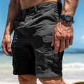Detailed close-up of men's dark grey outdoor cargo shorts featuring multiple utility pockets - S / Bottoms / Black