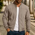 Close-up detail of men's taupe suede bomber jacket with front zipper and ribbed cuffs - S / Tops / Khaki