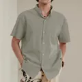 Detail view of men's sage green linen shirt with mandarin collar and front pocket - Khaki Grey
