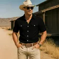 Close-up of men's black short-sleeve utility shirt with double pockets on model. - S / Tops / Black