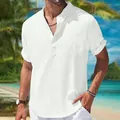 Detail of men's loose white cotton linen short sleeve shirt with stand collar on tropical beach - S / Tops / White