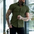 Detailed close-up of olive green muscle fit short sleeve shirt on tattooed male model - Army Green