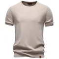 Detailed texture of a men's round neck knit t-shirt in beige with soft drape - S / Tops / Apricot