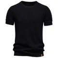 Detailed view of a premium black men's crew neck knit T-shirt with breathable mesh texture - S / Tops / Black