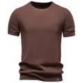 Detailed view of dark brown men's crew-neck knit T-shirt with waffle texture. - Brown
