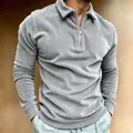 Detailed view of men's grey corduroy long-sleeved polo shirt featuring a quarter-zip collar - Gray