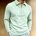 Macro view of men's mint green corduroy long sleeve polo shirt with half-zipper collar - Green