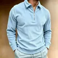 Close-up of men's light blue corduroy long-sleeved polo shirt with half-zip collar - S / Tops / Blue
