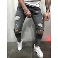 Close-up of men's dark grey ripped skinny jeans with distressed denim details. - S / Bottoms / Gray