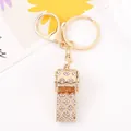 Elegante portachiavi a fischietto dorato con strass e motivo floreale per decoro borsa - Portachiavi Fischietto Strass Quadrifoglio / Oro