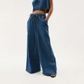 Detailed view of dark blue washed wide-leg denim pants for women with elastic waist. - XS / Bottoms / Blue
