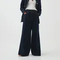 Detail showing the dark blue wide-leg denim pants with drawstring waist and deep pockets. - XS / Bottoms / Dark Blue