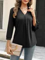 Detail view of women's black V-neck pullover top with pleated front design - Tops / Black / S
