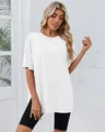 Close-up of women's white oversized T-shirt featuring a comfortable side slit detail design - S / Tops / White