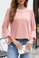 Detail of a pink round neck top featuring stylish contrast striped ribbing on cuffs - Pink