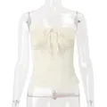 Detailed front view of a cream smocked tube top featuring an elegant ribbon bow - S / Tops / Apricot