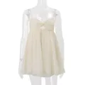 Close-up detail of a beige chiffon camisole with a twist-knot front and thin straps - S / Tops / Apricot