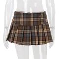 Macro view of vintage brown plaid pleated mini skirt showing metal button details - S / Bottoms / Brown