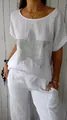 Detailed view of white cotton linen T-shirt featuring a shimmering rhinestone star. - S / Tops / White