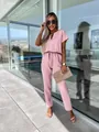 Close-up of elegant pink short-sleeved jumpsuit featuring V-neck and chic copper tube detail - S / Jumpsuits / Pink