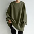 Close-up of olive green oversized sweatshirt with layered white hem detail - Army Green