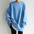 Detailed look at an oversized light blue crewneck sweatshirt for women - Light Blue