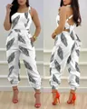 Detailed view of white jumpsuit with black feather print and backless bow tie design. - Leaf Print