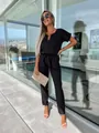 Elegant black V-neck short sleeve jumpsuit featuring a waist belt and metal accent detail - S / Jumpsuits / Black
