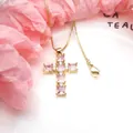Detail view of gold cross pendant necklace featuring brilliant pink square zircon stones - Necklace / Pink