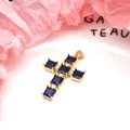 Detail of a gold-plated copper cross pendant with square blue and round white zircons. - Pendant Only / Dark Blue