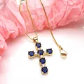 Detailed view of a gold cross pendant necklace featuring blue and white zirconia - Necklace Set / Dark Blue