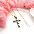 Detailed macro view of the gold cross pendant with blue and white cubic zirconia stones - Pendant Necklace Set / Dark Blue
