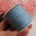 Detailansicht einer 0,8 mm blauen Baumwollschnur auf Spule für DIY-Schmuck und Basteln - 0.8mm / Hellblau