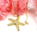 Macro view of a gold-colored starfish pendant necklace featuring a beaded texture - Starfish Style Necklace (5) / Pendant and Necklace Set