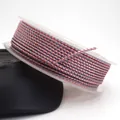 Detailed macro view of 1.5mm pink and grey dragon pattern braided cord wound on a clear spool. - Pink and Grey Dragon Cord (02#) / 1.5mm (10 Meters/Roll)
