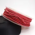 Close-up of 1.5mm red dragon pattern braided cord on a transparent plastic spool - Dragon Pattern Braided Cord (03#) / 1.5MM (ai-10m/Roll) / Red Pink