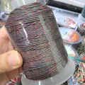Detaillierte Makroansicht einer 1,2 mm bunten, handgedrehten Baumwollfadenspule für DIY-Schmuck - Nr. 4 Ca. 1,2mm / Rot Grün Blau und Schwarz Gemischt