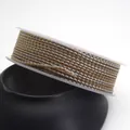 Detailed macro view of 1.5mm gold and silver dragon pattern braided cord on a white spool - Standard 1.5mm approx 1.6mm / Two-Tone Gold & Silver