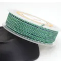Macro detail of 1.5mm green and blue dragon pattern braided cord on a transparent spool - Green and Blue Dragon Braided Cord (16#) / 1.5mm x 10 Meters Per Roll