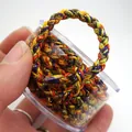 Nahaufnahme von 5mm buntem geflochtenem Drachenseil mit Goldfäden in Box - Nr.06