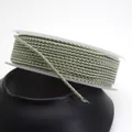 Detailed view of 1.5mm light green dragon pattern braided cord on a white spool - Standard 1.5mm approx 1.6mm / Bean Green